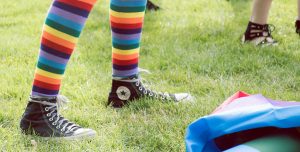 Person with rainbow striped socks.