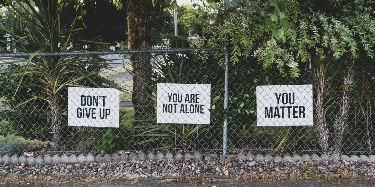 Green area with three positive message signs