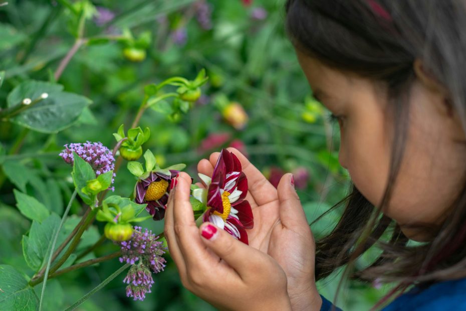 Girl looking at flower